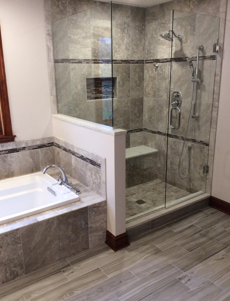 Tiled shower and bath in new bathroom renovations, glass screen doors