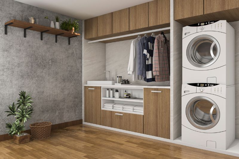 Laundry renovation with timber cabinetry and stacked washer and dryer